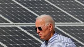 President Biden stands in front of solar panels